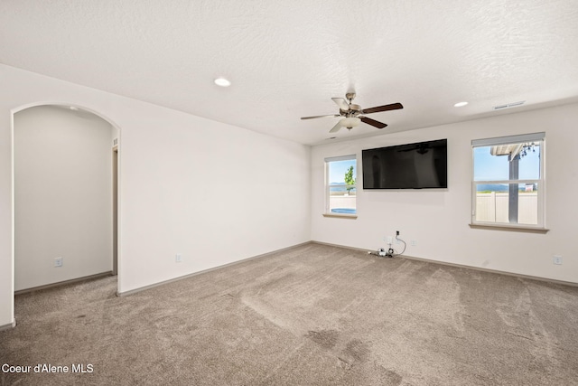 4717 N Connery Loop, Post Falls, ID 83854 - carpeted spare room with arched walkways, ceiling fan, recessed lighting, and a textured ceiling