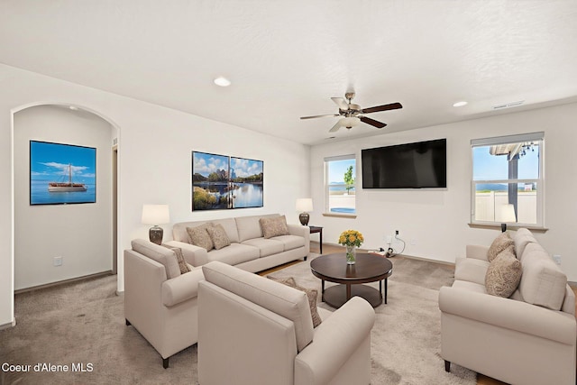 4717 N Connery Loop, Post Falls, ID 83854 - living room featuring light carpet, ceiling fan, recessed lighting, and arched walkways