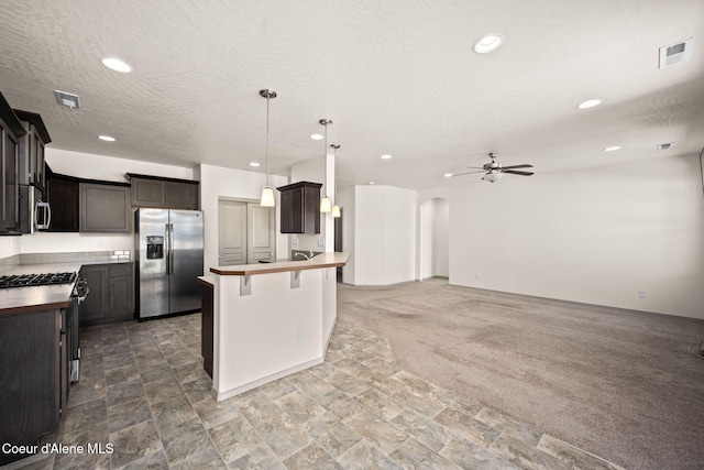 4717 N Connery Loop, Post Falls, ID 83854 - kitchen with appliances with stainless steel finishes, ceiling fan, open floor plan, a breakfast bar area, and recessed lighting