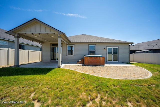 4717 N Connery Loop, Post Falls, ID 83854 - back of property with a hot tub, a patio area, and a fenced backyard