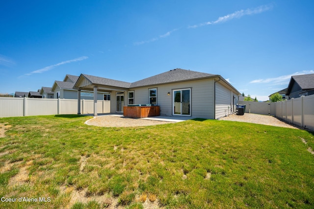 4717 N Connery Loop, Post Falls, ID 83854 - rear view of house with a hot tub, a fenced backyard, and a patio area