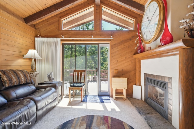471 Kaniksu Shores Rd, Sandpoint, ID 83864 - carpeted living room with wood walls, a glass covered fireplace, wood ceiling with exposed beams, and high vaulted ceiling