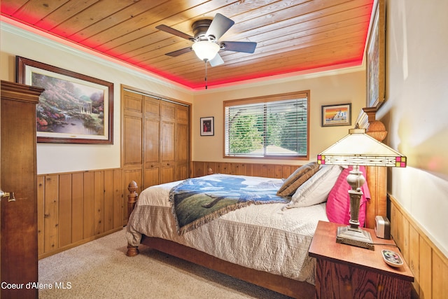 471 Kaniksu Shores Rd, Sandpoint, ID 83864 - bedroom featuring wainscoting, wood ceiling, wooden walls, carpet floors, and crown molding