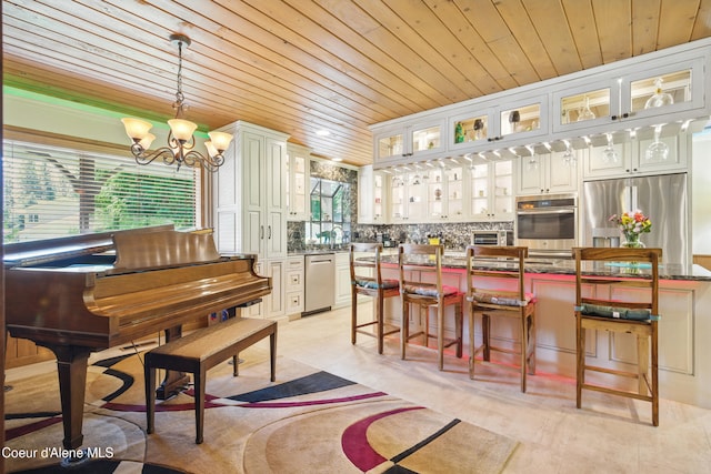 471 Kaniksu Shores Rd, Sandpoint, ID 83864 - kitchen featuring wood ceiling, plenty of natural light, stainless steel appliances, a chandelier, and hanging light fixtures
