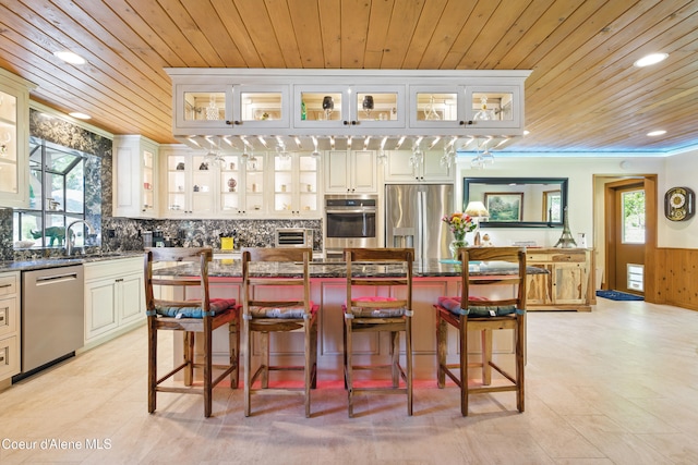 471 Kaniksu Shores Rd, Sandpoint, ID 83864 - kitchen with stainless steel appliances, wood ceiling, plenty of natural light, a sink, and a kitchen island