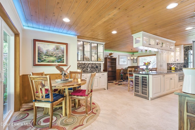 471 Kaniksu Shores Rd, Sandpoint, ID 83864 - dining space featuring beverage cooler, wood ceiling, recessed lighting, crown molding, and a chandelier