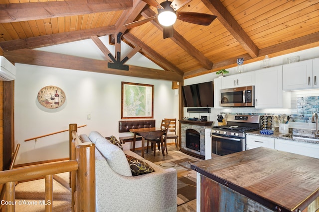 471 Kaniksu Shores Rd, Sandpoint, ID 83864 - living area featuring wooden ceiling, ceiling fan, a fireplace, and light wood-type flooring