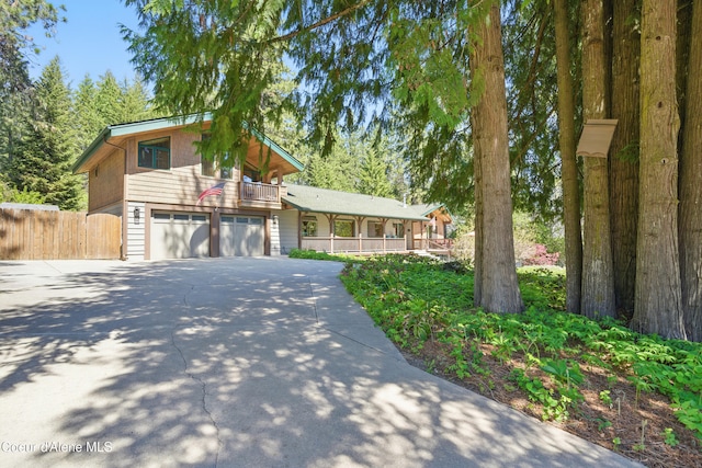 471 Kaniksu Shores Rd, Sandpoint, ID 83864 - view of front of home featuring driveway, a garage, and covered porch