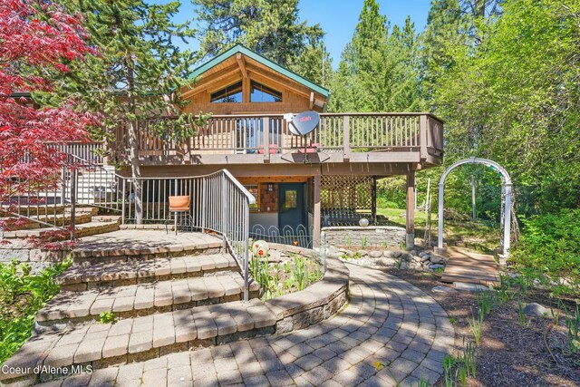 471 Kaniksu Shores Rd, Sandpoint, ID 83864 - back of property featuring a wooden deck, stairway, and a patio