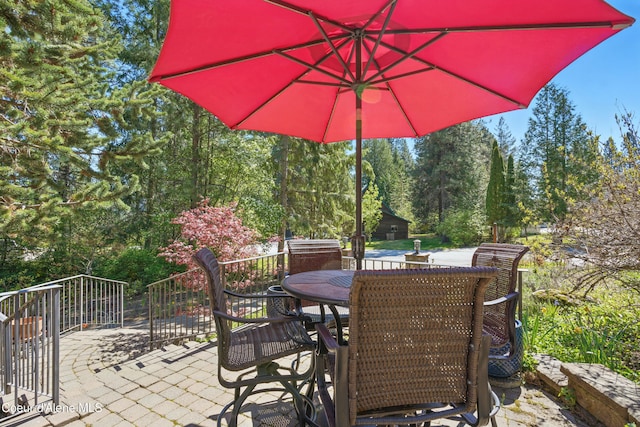 471 Kaniksu Shores Rd, Sandpoint, ID 83864 - view of patio / terrace featuring outdoor dining space and view of scattered trees