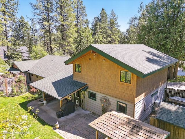 471 Kaniksu Shores Rd, Sandpoint, ID 83864 - rear view of house with a patio, a shingled roof, and central AC