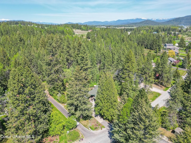 471 Kaniksu Shores Rd, Sandpoint, ID 83864 - drone / aerial view of a heavily wooded area and a mountainous background