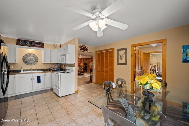6918 E Garwood Rd, Hayden, ID 83835 - kitchen with white appliances, a ceiling fan, white cabinets, a sink, and light tile patterned floors