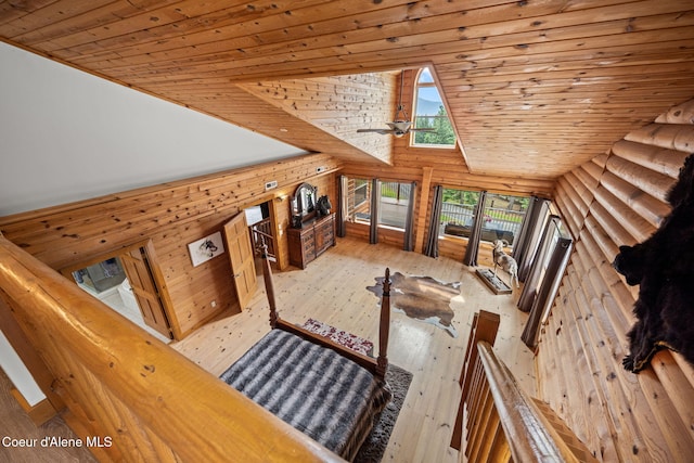 6918 E Garwood Rd, Hayden, ID 83835 - unfurnished living room featuring wood ceiling, high vaulted ceiling, wooden walls, and hardwood / wood-style floors