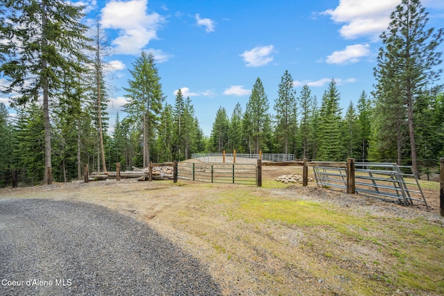 6918 E Garwood Rd, Hayden, ID 83835 - view of street with an enclosed horse arena, a view of trees, and an exterior structure