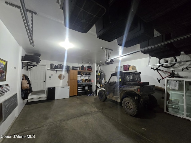 10566 N Seaside St, Hayden, ID 83835 - garage featuring a garage door opener and water heater