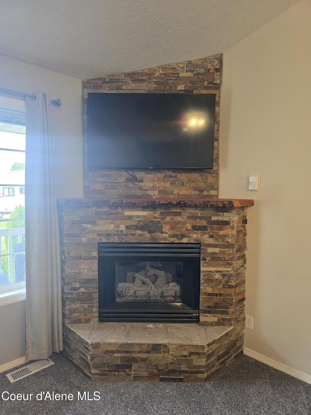 10566 N Seaside St, Hayden, ID 83835 - detailed view of a fireplace, carpet floors, and baseboards