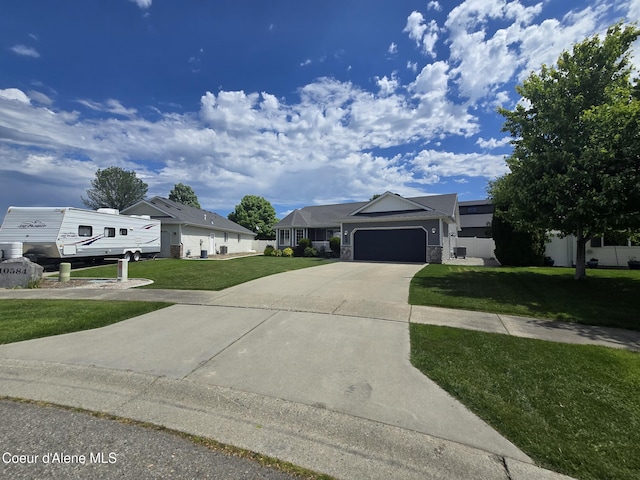 10566 N Seaside St, Hayden, ID 83835 - ranch-style home with a front lawn, an attached garage, concrete driveway, and stone siding