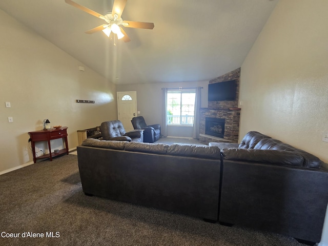 10566 N Seaside St, Hayden, ID 83835 - living area with lofted ceiling, a stone fireplace, ceiling fan, dark colored carpet, and baseboards