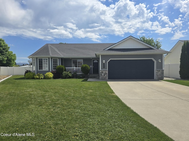 10566 N Seaside St, Hayden, ID 83835 - ranch-style home featuring a garage, concrete driveway, a porch, and stone siding