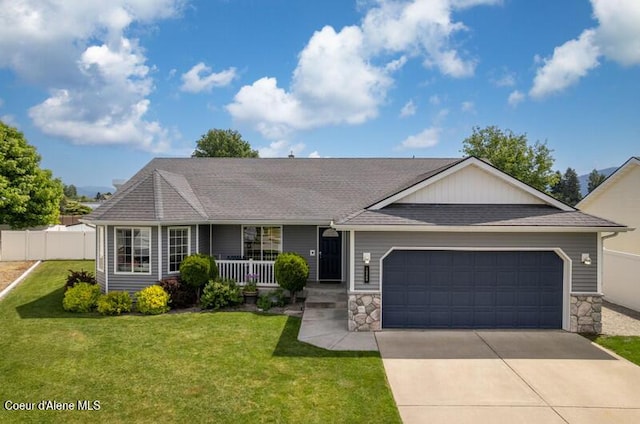 10566 N Seaside St, Hayden, ID 83835 - single story home with a garage, a porch, concrete driveway, and stone siding