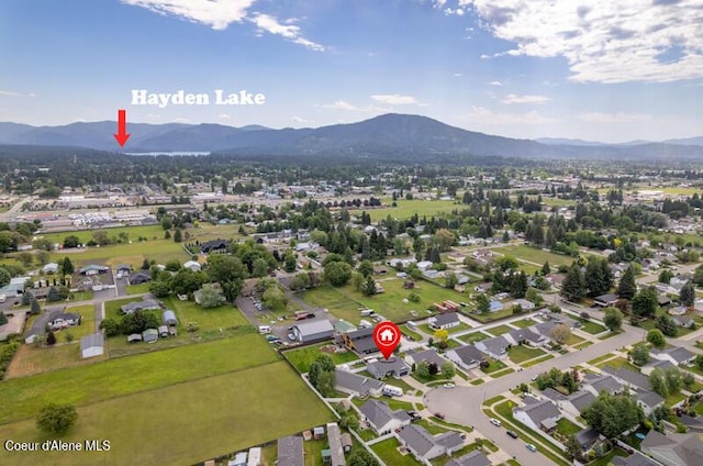10566 N Seaside St, Hayden, ID 83835 - aerial view of property and surrounding area featuring a mountain backdrop and nearby suburban area