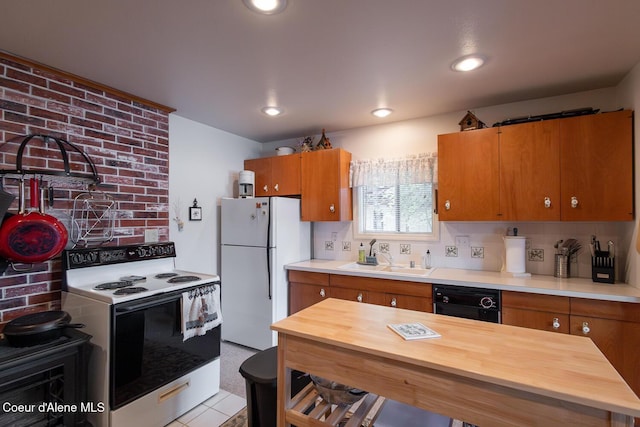 97 S Granite Bay Rd, Nordman, ID 83848 - kitchen featuring range with electric stovetop, a sink, freestanding refrigerator, black dishwasher, and brown cabinets