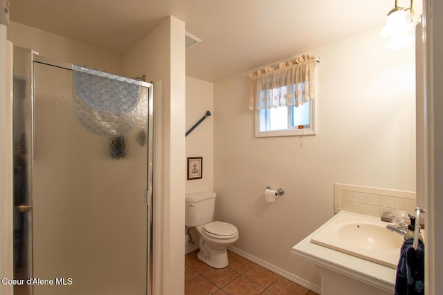 97 S Granite Bay Rd, Nordman, ID 83848 - full bathroom featuring a stall shower, tile patterned flooring, toilet, vanity, and baseboards
