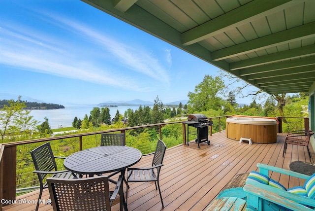 521 Aspen, Hope, ID 83836 - wooden terrace featuring a hot tub, grilling area, a water and mountain view, and outdoor dining area