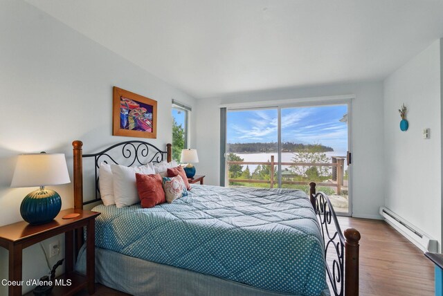 521 Aspen, Hope, ID 83836 - bedroom featuring a baseboard heating unit, wood finished floors, access to exterior, and a water view