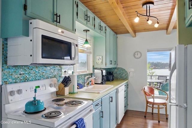 521 Aspen, Hope, ID 83836 - kitchen featuring white appliances, a sink, wood ceiling with exposed beams, plenty of natural light, and dark wood-style flooring