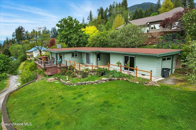 521 Aspen, Hope, ID 83836 - rear view of house with an attached garage, a yard, a deck, and a chimney