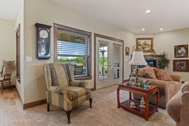 2795 Boekel Rd, Rathdrum, ID 83858 - living area with recessed lighting, baseboards, light wood finished floors, french doors, and a glass covered fireplace