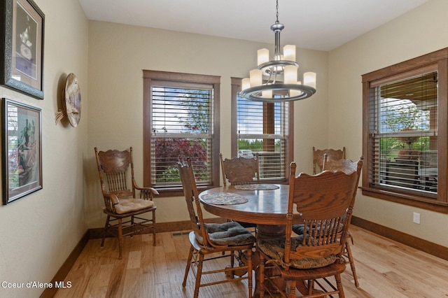 2795 Boekel Rd, Rathdrum, ID 83858 - dining space with light wood-style floors, a chandelier, and baseboards