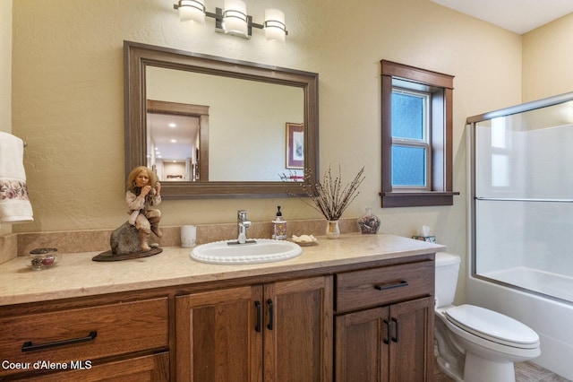 2795 Boekel Rd, Rathdrum, ID 83858 - full bathroom featuring vanity, toilet, and bath / shower combo with glass door