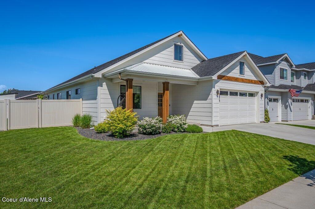 6873 N Degas Dr, Coeur Dalene, ID 83815 - view of front facade featuring concrete driveway, an attached garage, and a porch