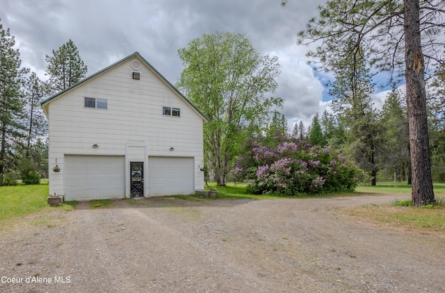 919 Silver Springs Rd, Moyie Springs, ID 83845 - view of side of property with dirt driveway and an attached garage