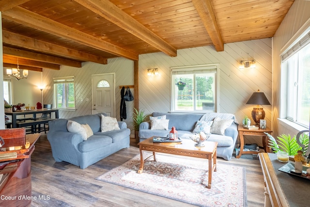 919 Silver Springs Rd, Moyie Springs, ID 83845 - living area with a chandelier, wood finished floors, wood ceiling with exposed beams, and wooden walls