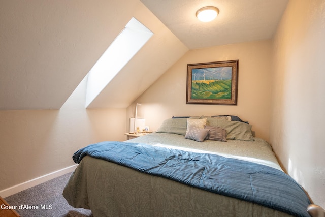 919 Silver Springs Rd, Moyie Springs, ID 83845 - carpeted bedroom featuring lofted ceiling, baseboards, and a skylight