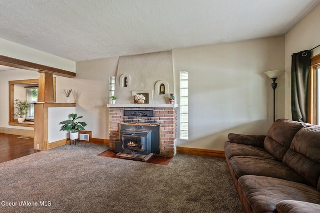 112 Washington St, Priest River, ID 83856 - living area with a brick fireplace, carpet, baseboards, plenty of natural light, and a textured ceiling