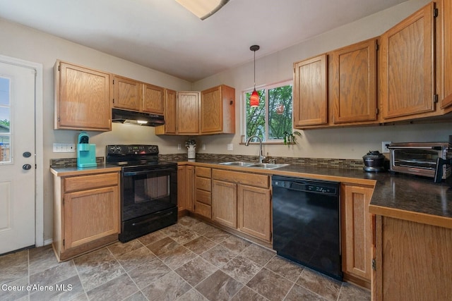 112 Washington St, Priest River, ID 83856 - kitchen with black appliances, a sink, under cabinet range hood, dark countertops, and stone finish floors
