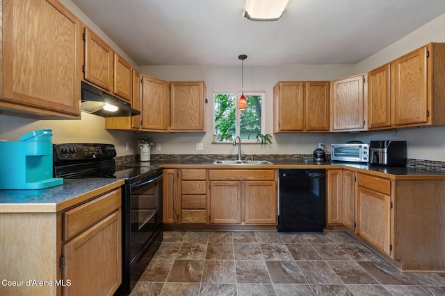 112 Washington St, Priest River, ID 83856 - kitchen featuring black appliances, under cabinet range hood, a sink, dark countertops, and dark stone finish floors