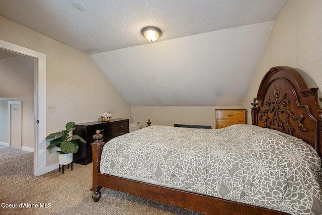 112 Washington St, Priest River, ID 83856 - bedroom with carpet floors, lofted ceiling, a textured ceiling, and baseboards