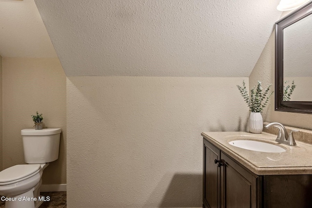 112 Washington St, Priest River, ID 83856 - bathroom with vaulted ceiling, toilet, and vanity