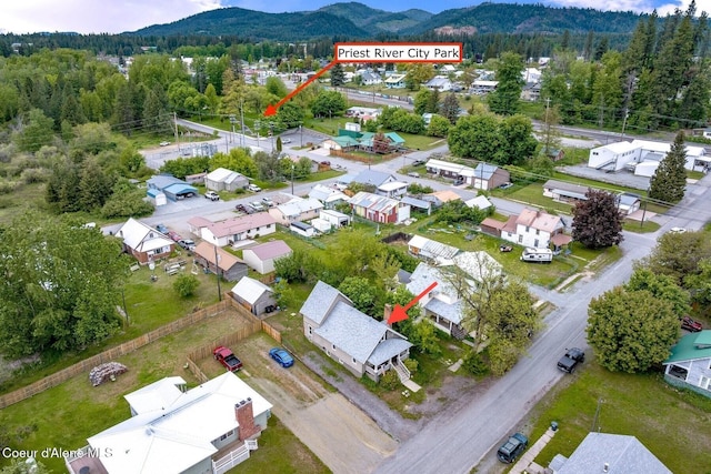 112 Washington St, Priest River, ID 83856 - aerial view of residential area with a mountainous background and a forest
