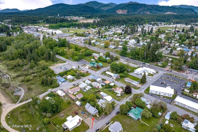 112 Washington St, Priest River, ID 83856 - aerial overview of property's location with a mountain backdrop and a heavily wooded area