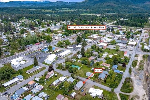 112 Washington St, Priest River, ID 83856 - aerial view of property and surrounding area featuring a mountainous background and a forest
