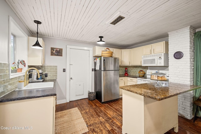 15152 N Mill St, Rathdrum, ID 83858 - kitchen featuring white appliances, a sink, a peninsula, dark wood finished floors, and tasteful backsplash