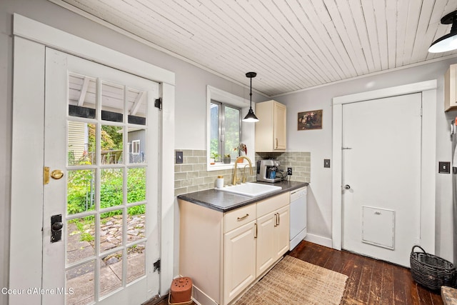 15152 N Mill St, Rathdrum, ID 83858 - kitchen featuring a sink, white dishwasher, dark countertops, dark wood-type flooring, and decorative backsplash