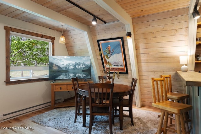 11 Hackney Ln, Sandpoint, ID 83864 - dining room featuring wooden ceiling, wood walls, baseboard heating, wood finished floors, and track lighting